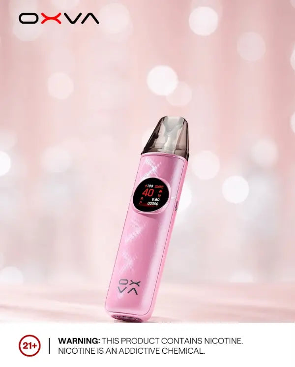 A pink OXVA disposable vape device with a digital screen, set against a soft pink bokeh background. A white banner at the bottom contains a nicotine warning. ORDER NOW AND GET FREE DELIVERY